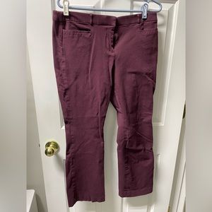A Pair of burgundy dress pants.